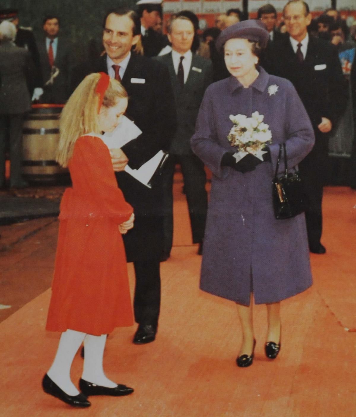 Hannah Bulmer presents flowers to the Queen during her 1987 visit to the factory