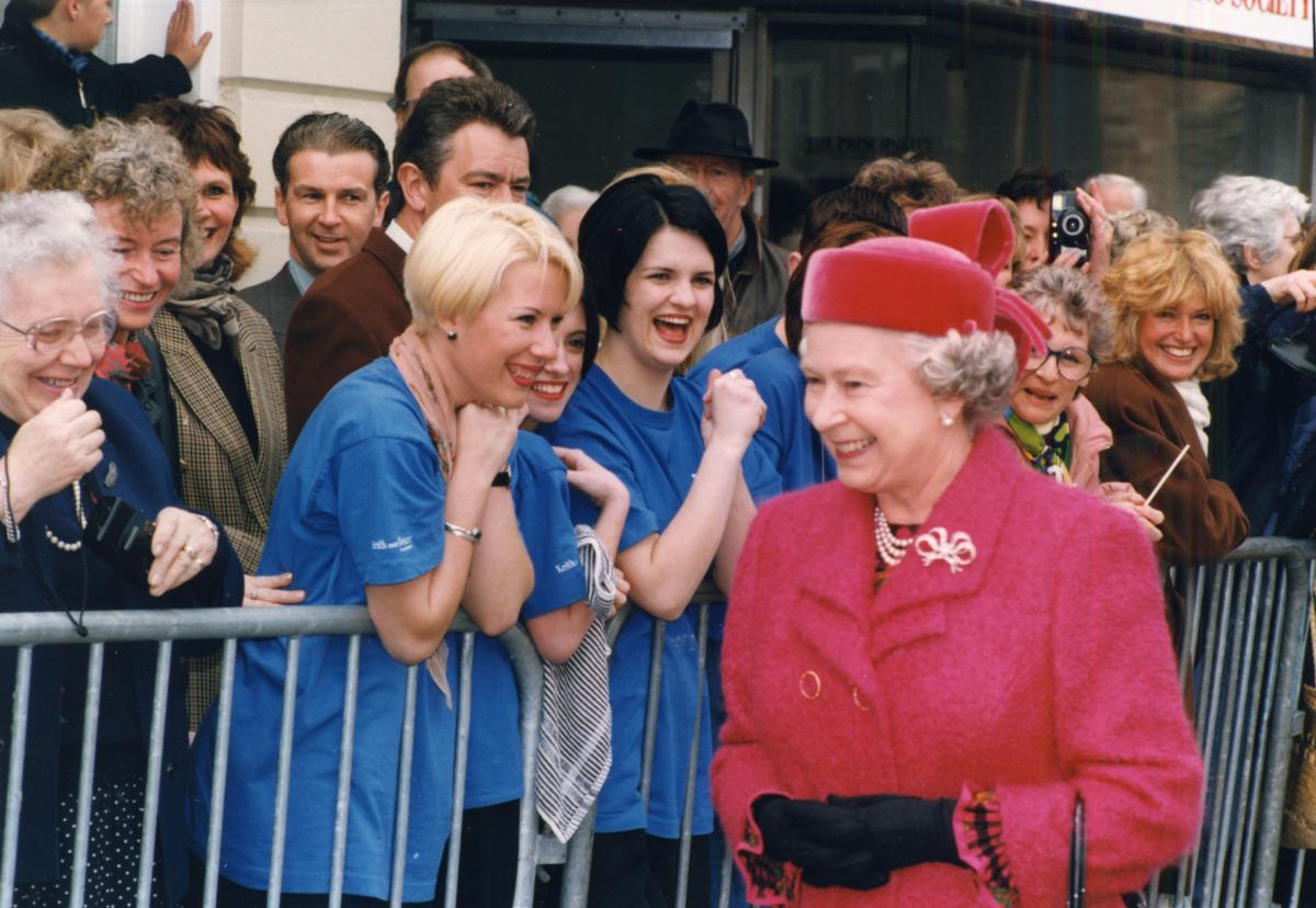 Sharing a joke with staff at Keith and Peter's hairdressers, during her 1996 visit