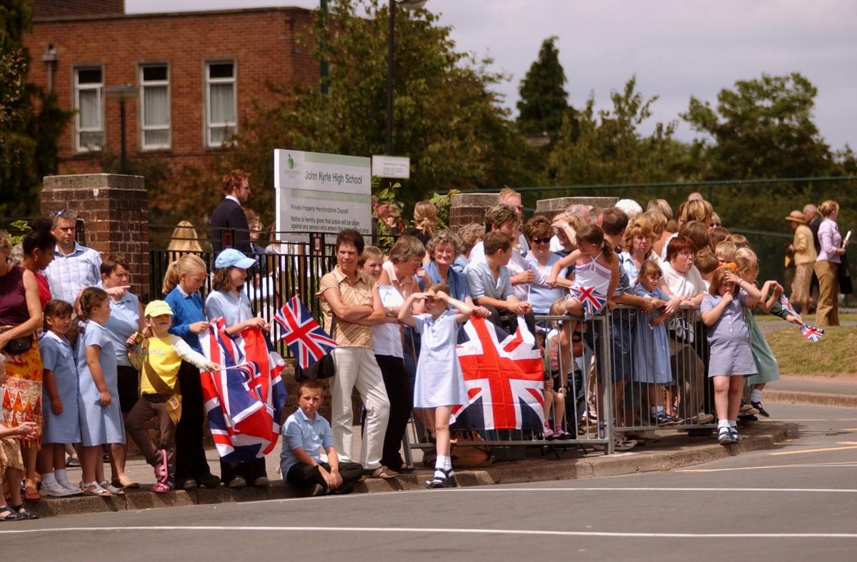 Excited crowds outside John Kyrle High School in 2003, waiting to see the Queen