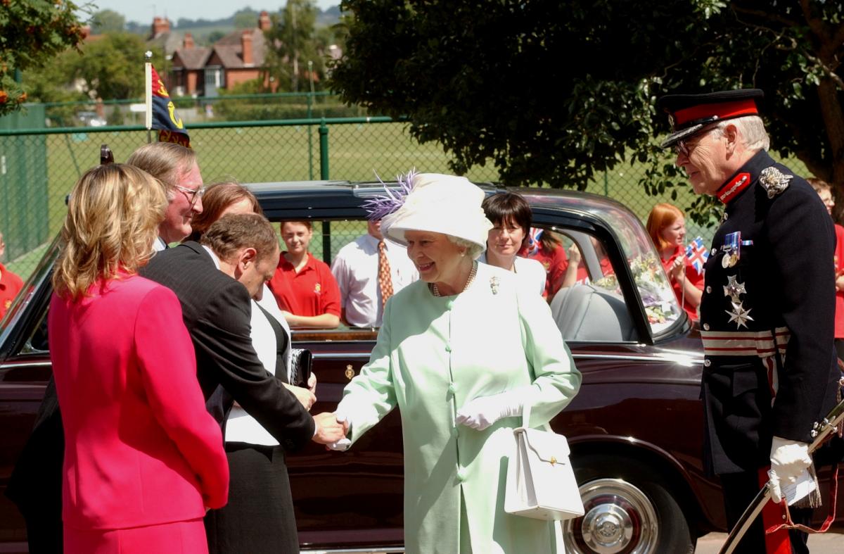 John Kyrle High School headteacher Nigel Griffiths greets the Queen as she arrives at John Kyrle High School