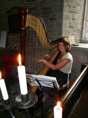 Susy Stark playing the harp at St. James Church Llangua