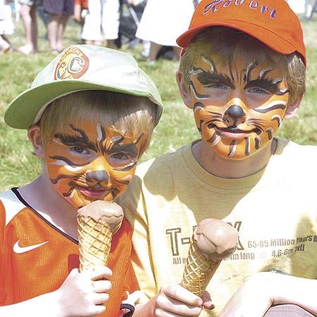 William & Robert Wassink enjoy an ice cream after having their faces painted.