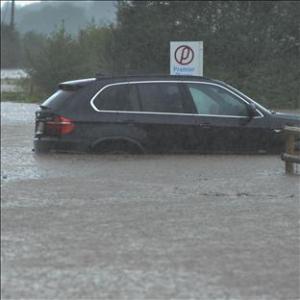Two cars are left stranded in flood waters on the A443 near Eardiston, Worcestershire