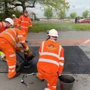 Workers demonstrating the effectiveness of mastic asphalt