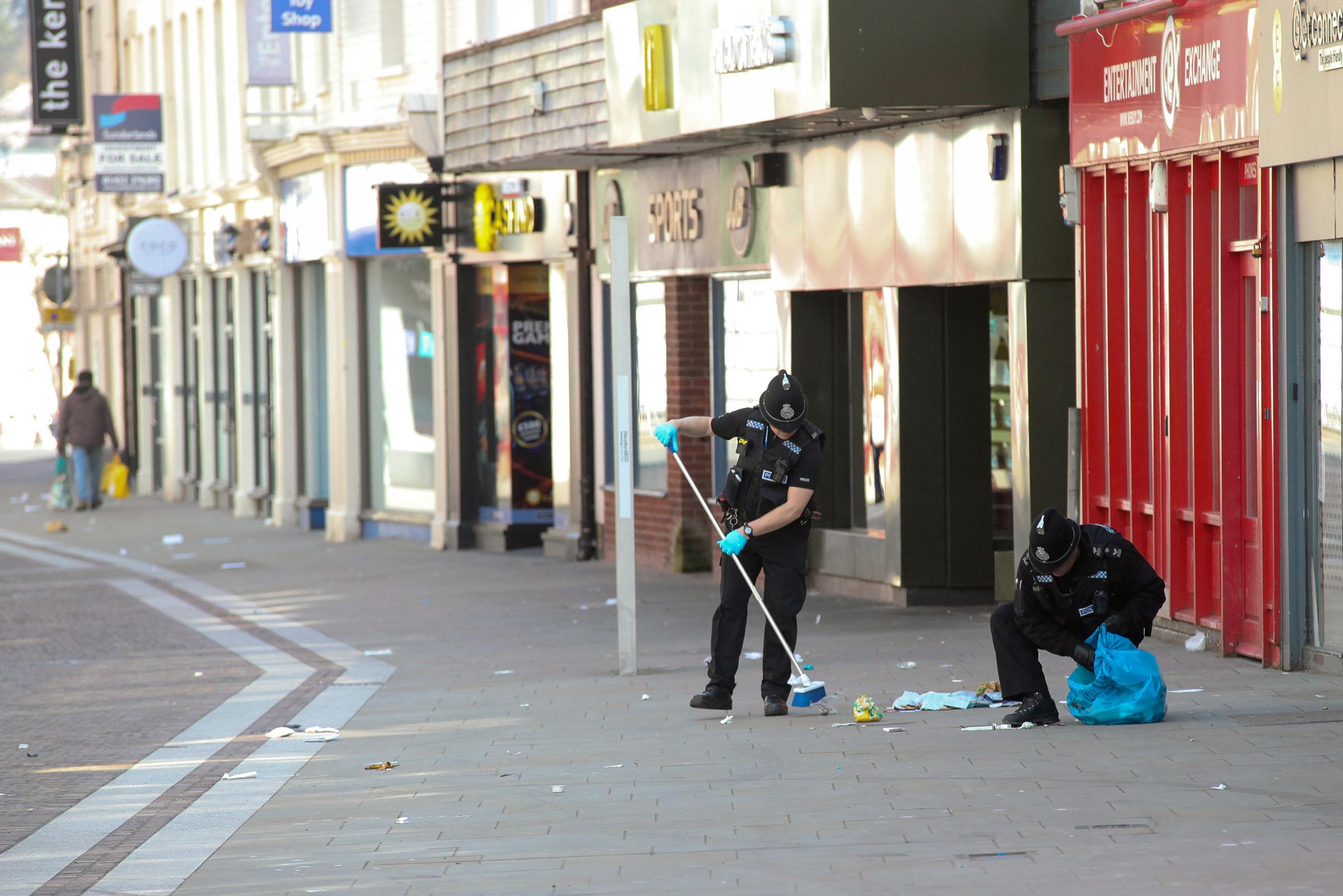 Scenes from around Hereford after Governments coronavirus lockdown...Pic is. Police clean up litter on Commercial Street in Hereford city center..