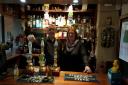 Dean Cholmondeley, left, behind the bar at Plough Inn in Little Dewchurch