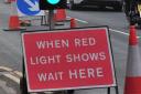 Temporary traffic lights are still on the B4399 almost a year after storm damage. Stock picture