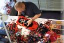 A man assembling LEGO's new Technic Ferrari Daytona SP3. Credit: LEGO