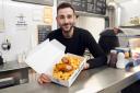 Chippy owner, Zac Zachariou with his battered pigs in blankets and chips. Picture: Rob Davies