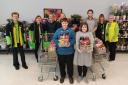 Staff at Hereford's Asda in Belmont Road have handed over movie night food packs for children to enjoy while watching themselves on CBBC show Operation Ouch. Picture: Wye Valley NHS Trust