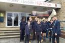 Queen Elizabeth High School head of school Seb Seneque, right, with pupils outside the main entrance after Ofsted found it was still a good school