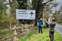 Passers-by stop to take a selfie with the famous Llandegley International Airport sign