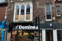 The pigeons were trapped in a window above Domino's
