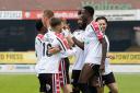 Hereford players celebrate a debut goal for Yusifu Ceesay during their 2-0 win over Anstey Nomads