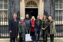 Postmasters Tim Allen and Jenny Cains from Kington and Malvern with campaign supporters at 10 Downing Street