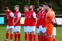 Hereford Pegasus players observe a minute of silence ahead of their game at Wantage Town