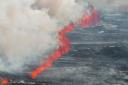 An eruptive fissure spews lava and smoke (AP Photo/Marco di Marco)