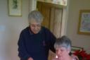 Photo shows Sue Collett showing Elaine Oxborrow the art of spinning