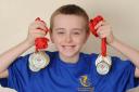 Oliver Jones won 13 gold medals and a silver medal at the South East Wales Swimming Championships. Photo: James Maggs