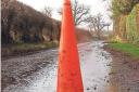 A traffic cone marks a pothole in Lower Breinton.