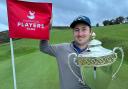 Daniel Brooks with the end of year European Players Tour championship trophy on the 18th green
