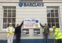 Extinction Rebellion activists have dressed as cleaners as they target Hereford's Barclays bank