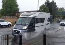 A camper van drives through a puddle on the Straight Mile in Hereford
