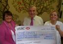 Merry Millers Ian Pugh (Centre) and Janey Cotton (left) present their £13,111 cheque to Haven community fundraiser Lesley Leach