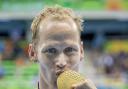 CHAMPION: Sascha Kindred kisses his gold medal after smashing the world record time in the SM6 200m individual medley. Photos: onEdition