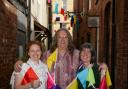 From left: Gaynor Lewin (Jumping Ships), Martin Nicholas (The Light Shop) and Val Mifflin (Parry's) from Leominster Business Group with the 'washing line' bunting on Butcher's Row. Photo: James Maggs.