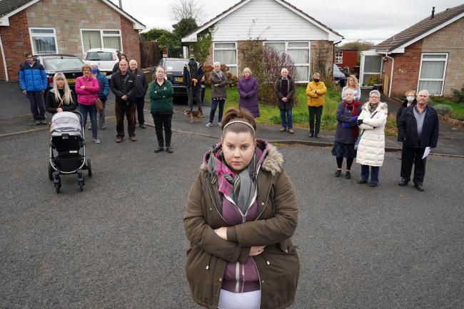 Jordan Pinwell (centre) and her young family would have to move out of the bungalow behind her, which would be demolished to provide access to the new estate. Picture: Rob Davies