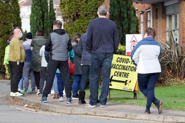 Hereford Times: People were queueing outside Elgar House, Holmer Road, as a walk-in Covid jab clinic opened. Picture: Rob Davies