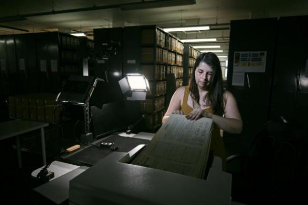 Hereford Times: Photo via PA shows Findmypast technician Laura Gowing scans individual pages of the 30,000 volumes of the 1921 Census at the Office for National Statistics (ONS) near Southampton.