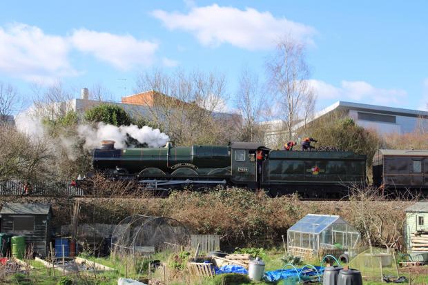 Hereford Times: The classic loco Clun Castle steams past allotments. Picture: James Rippard