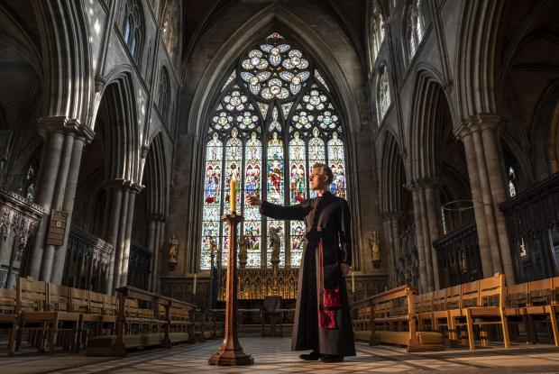 Hereford Times: Very Reverend John Dobson Dean of Ripon lights a candle to mark the second anniversary of the first national coronavirus lockdown at Ripon Cathedral, North Yorkshire, ahead of the National Day of Reflection on Wednesday (PA)