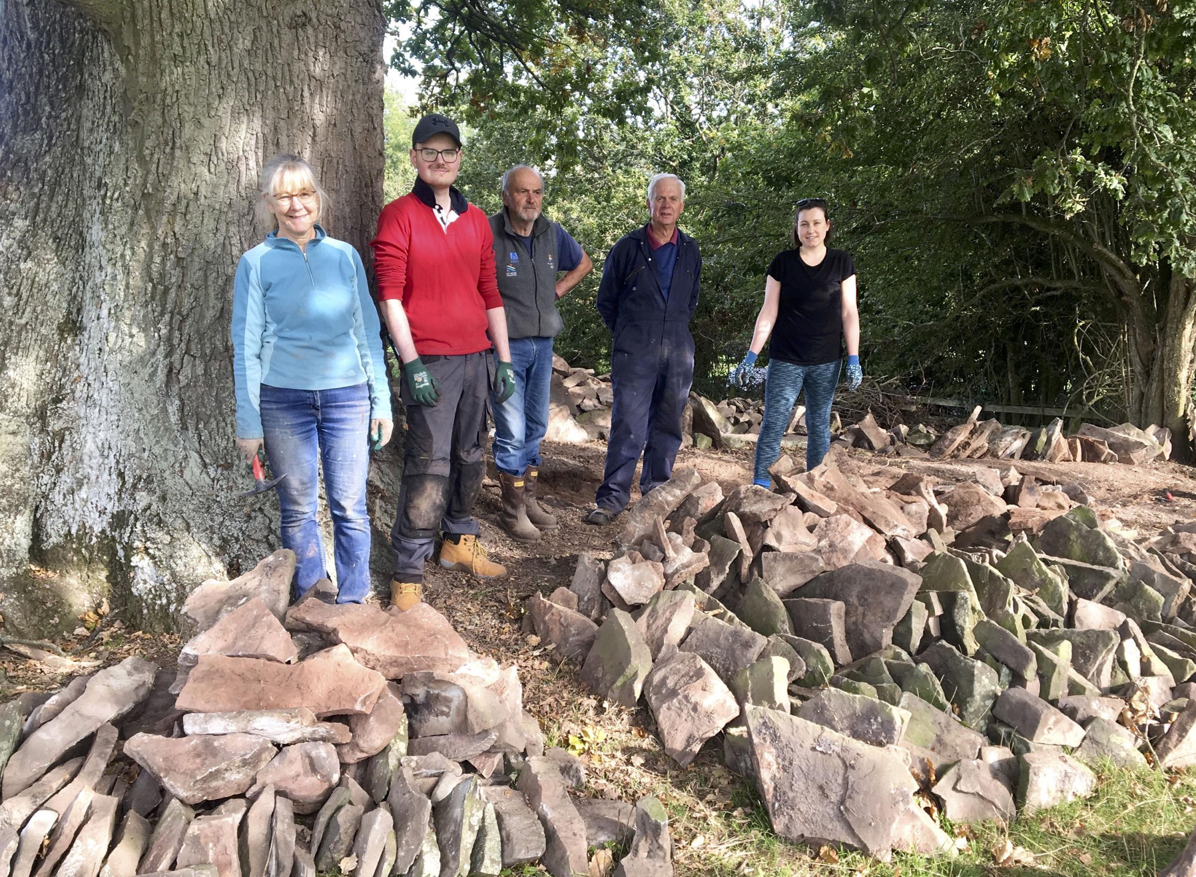 Some of the volunteers from Hay Community Woodland Group who took down part of the wall at The Warren, Hay-on-Wye, and sorted the stone