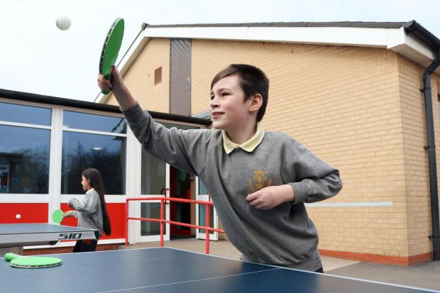 Hereford Times: Year 6 pupil Calvin Wride plays table tennis on the school's outside table