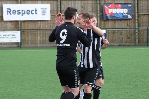 Tom Boyle congratulating Scott Roberts after his team-mate nodded home a second goal for Ledbury Town in their 6-1 win over Hereford Lads Club Reserves. Picture: Chris Ponter
