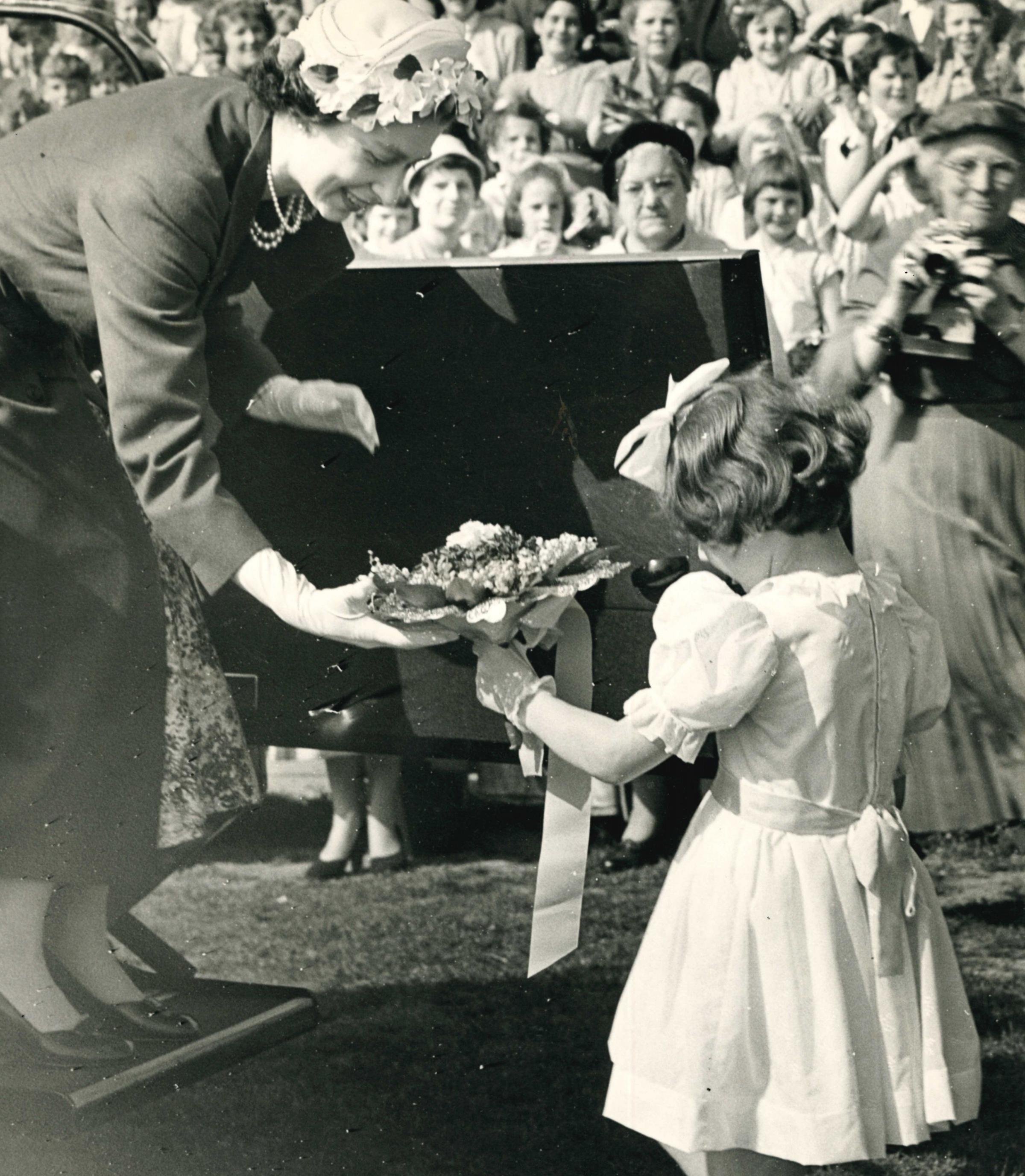 The Queen takes a gift during her visit in 1957
