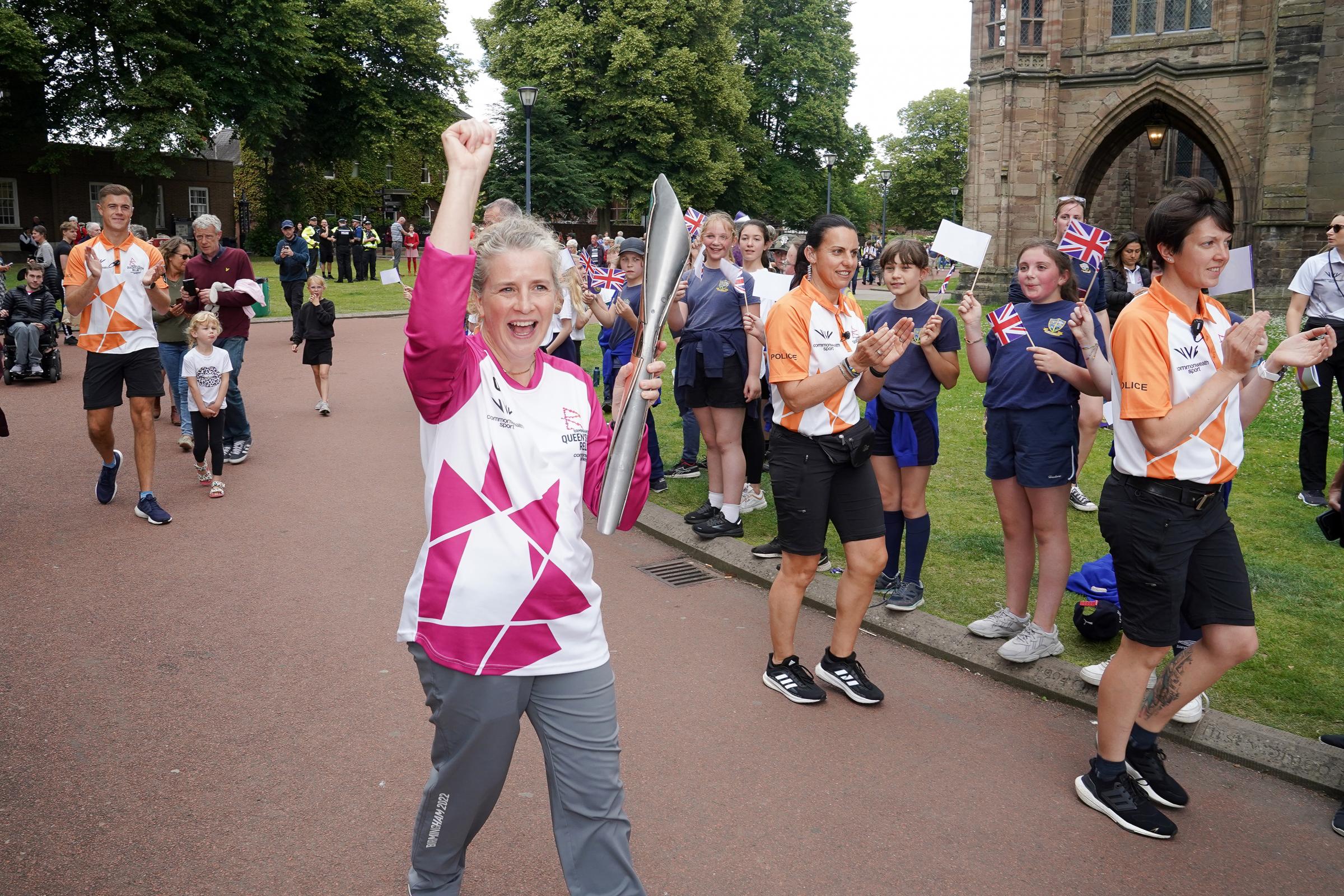 Batonbearer, Emma Jones returns the Commonwealth games relay baton to Hereford Cathedral.