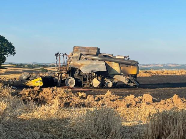 Hereford Times: The combine harvester that caught fire in Westhope Picture: Kingsland fire station