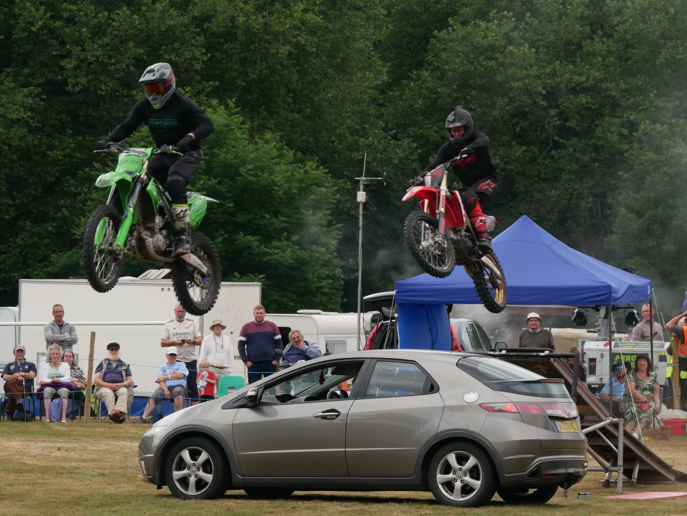 Flying Ryan motorcycle stunt team jump a car in the main ring. Picture: Andy Compton