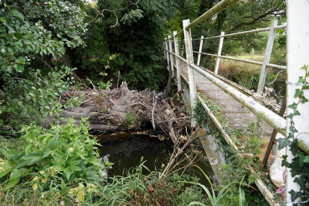 Wood debris piled up underneath the footpath bridge in Staunton-on-Arrow