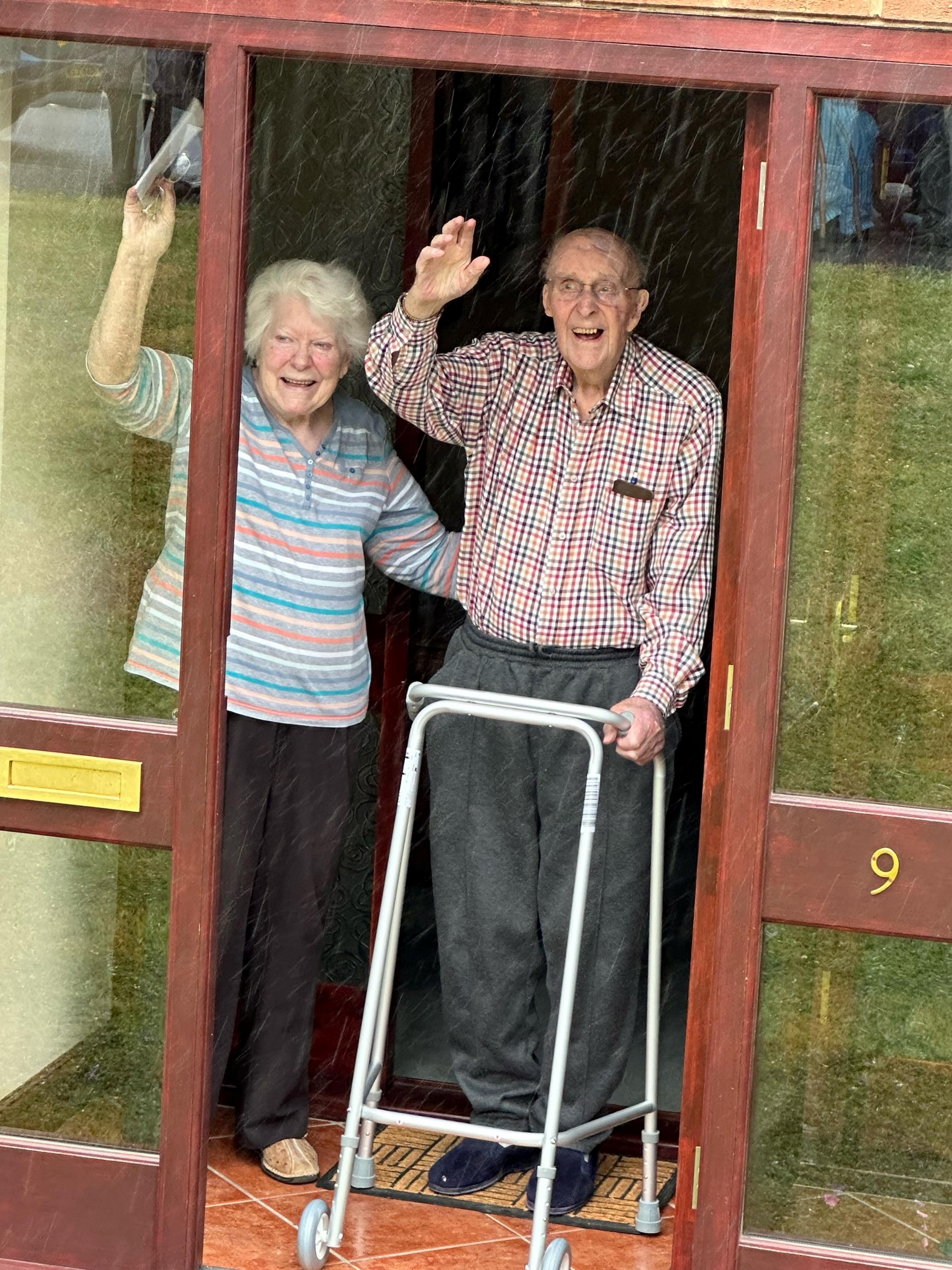 Irene and Barry Holmer acknowledge their neighbours birthday wishes as Barry turns 103