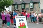 In the centre of the photograph Ben being welcomed to Knighton by his wife Krissi watched by others in the welcoming party.