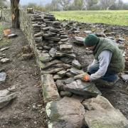 Stone mason Dai Davies rebuilding the wall at The Warren, Hay-on-Wye