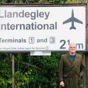 Nicholas Whitehead with his infamous 'Llandegley International Airport' sign which was made in Wrexham.