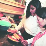 Rayeesa Asghar-Sandys – pictured, left, with a pupil – will teach visitors how to cook at the Big Curry event at Hereford Racecourse.