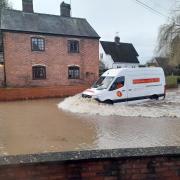 An O'Connor Utilities van driving through floodwater in Eardisland