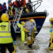 Asylum seekers being brought in to Dungeness, Kent, by the RNLI